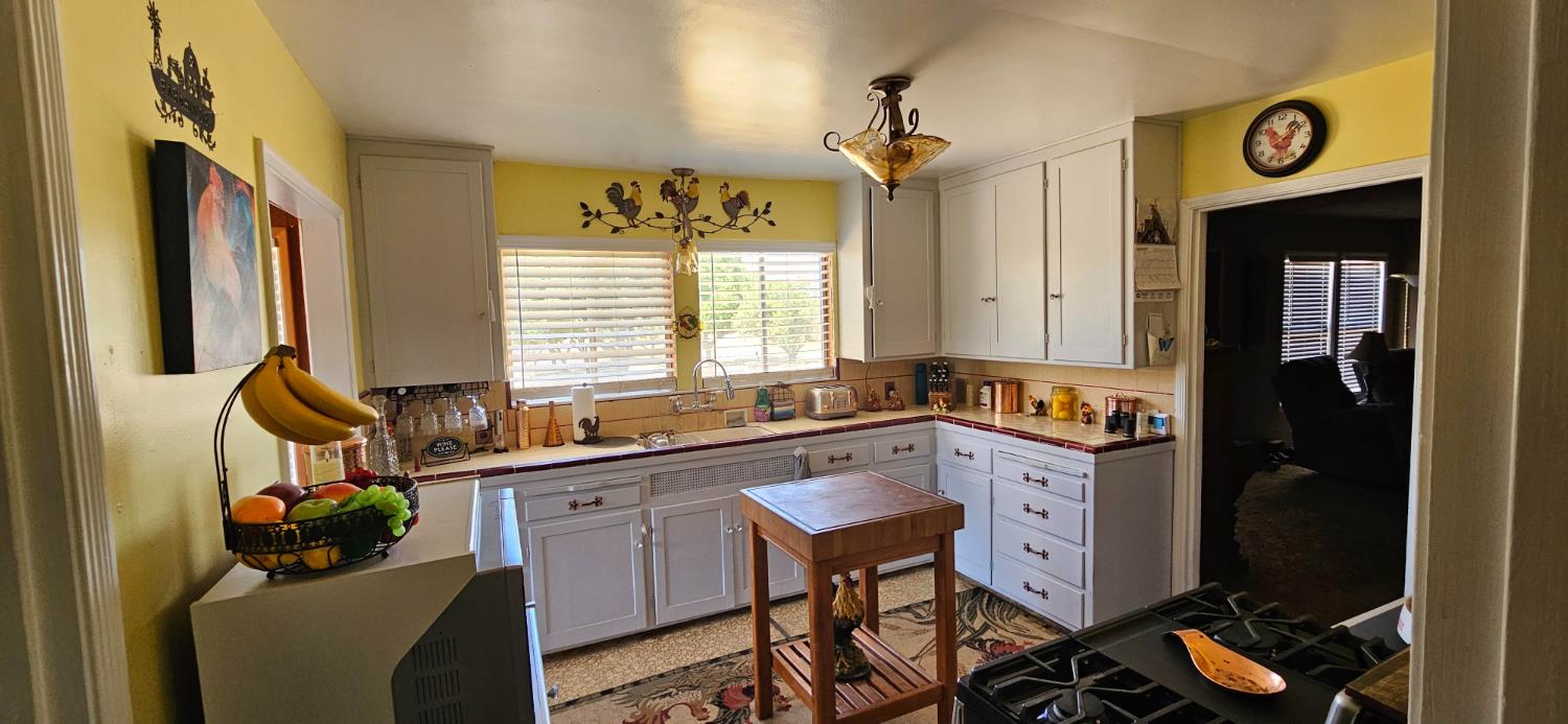 20822 Disch Road Lockeford, CA 95237 - Photo 7 of 30 a kitchen with a sink stove and cabinets