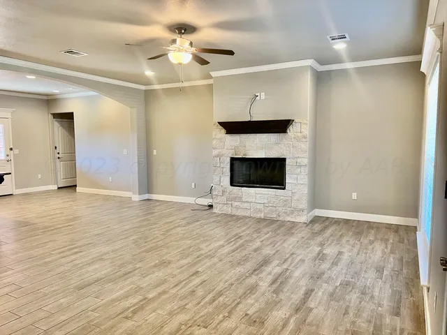 wooden floor fireplace and windows in a room