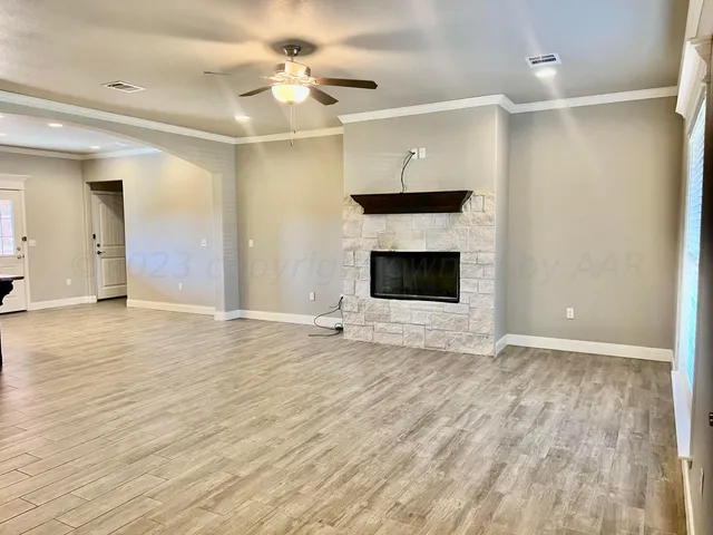 wooden floor fireplace and windows in a room