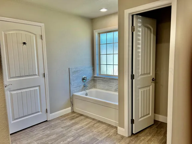 a bathroom with a tub and shower