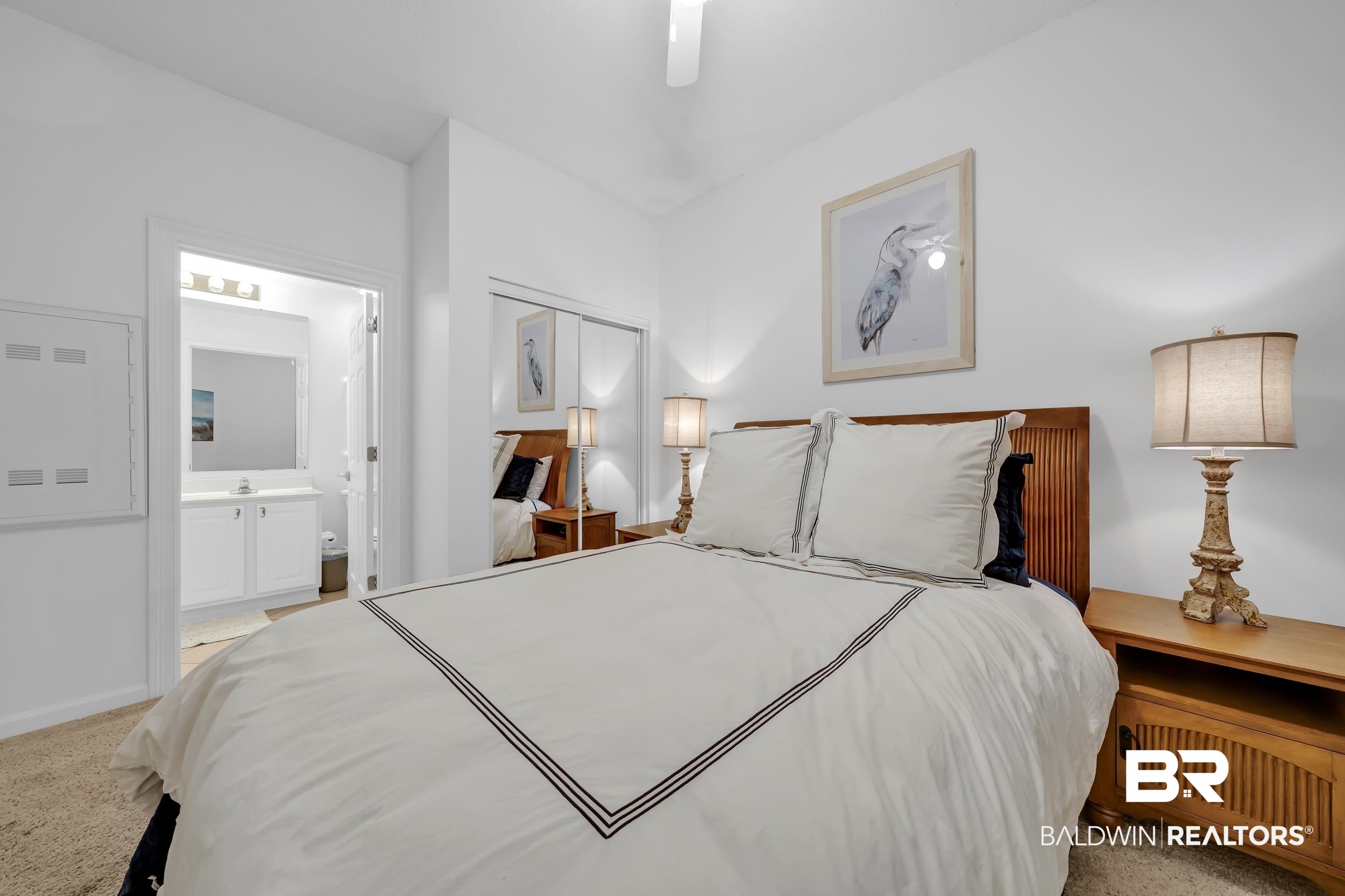 27282 Canal Road, Unit 104 Orange Beach, AL 36561 - Photo 44 of 79 Bedroom featuring light colored carpet, connected bathroom, a closet, and a ceiling fan