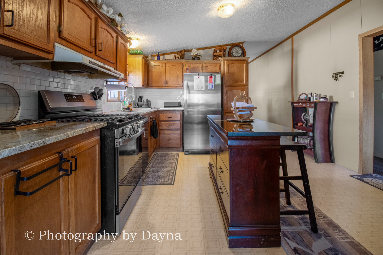 85 St Michaels Drive Bourbonnais, IL 60914 - Photo 7 of 14 a kitchen with stainless steel appliances granite countertop a stove a refrigerator and a microwave