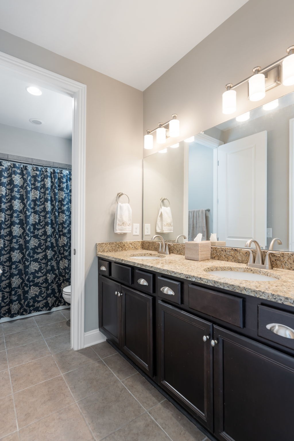 320 Fitzgerald Street Franklin, TN 37064 - Photo 52 of 64 a bathroom with a granite countertop sink a large mirror and a shower