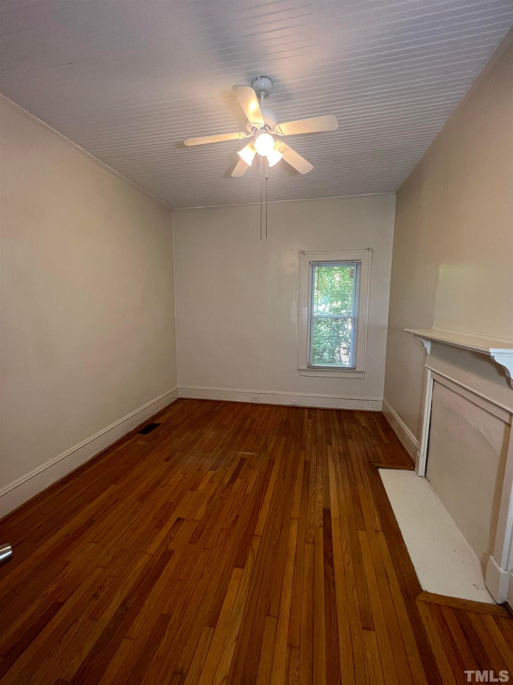 9 Dixie Trail Raleigh, NC 27607 - Photo 4 of 8 wooden floor in an empty room with a window