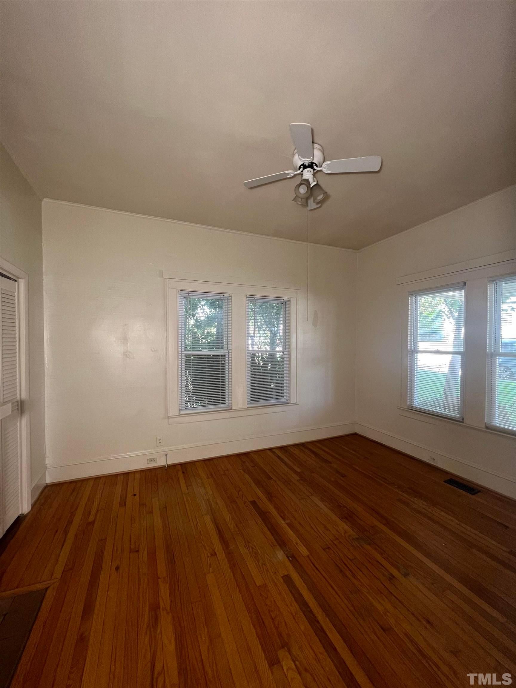 9 Dixie Trail Raleigh, NC 27607 - Photo 5 of 8 wooden floor in an empty room with a window