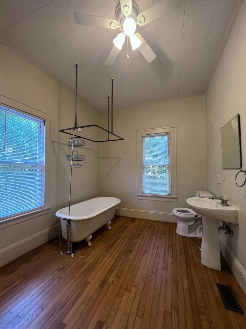 9 Dixie Trail Raleigh, NC 27607 - Photo 8 of 8 a living room with a window hardwood floor and a ceiling fan