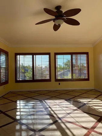 a bedroom with a bed and two windows