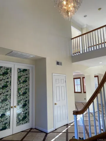 a view of staircase with railing and a large window