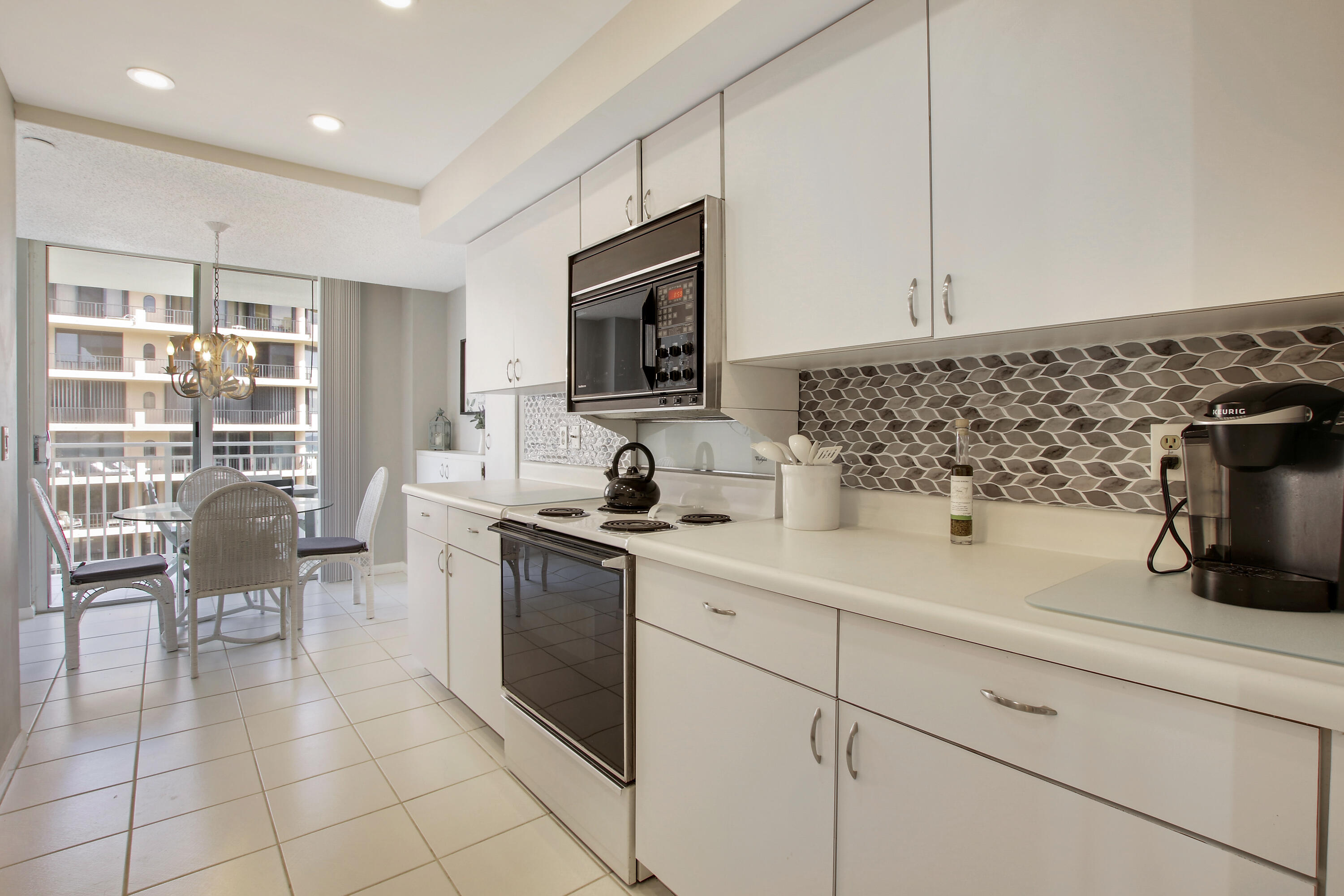 500 Ocean Drive, Unit E9A Juno Beach, FL 33408 - Photo 15 of 21 a kitchen with a sink cabinets and appliances
