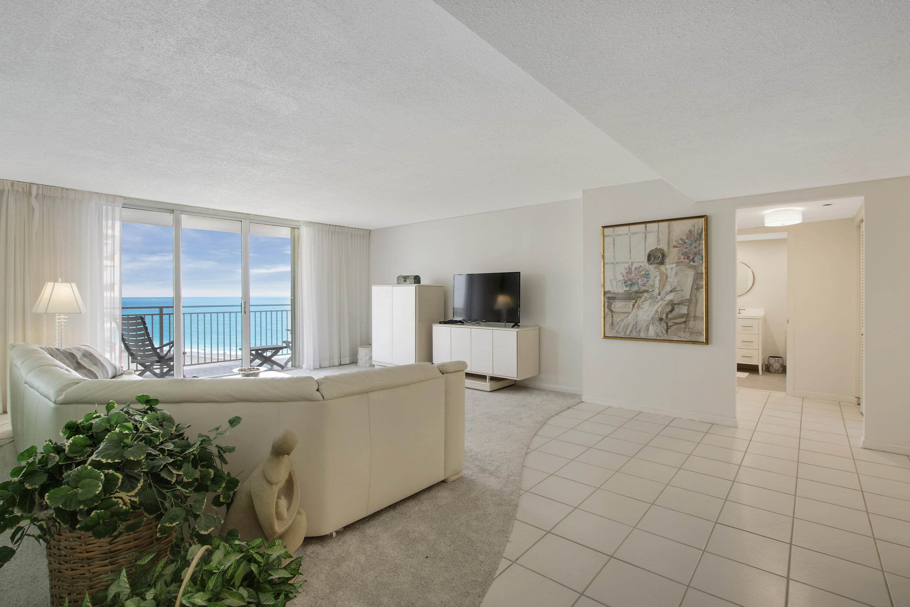 500 Ocean Drive, Unit E9A Juno Beach, FL 33408 - Photo 5 of 21 a living room with furniture and a large window