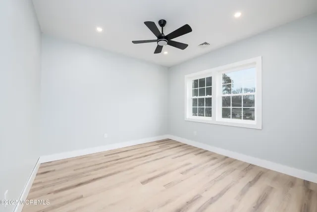 a view of a ceiling fan and wooden floor