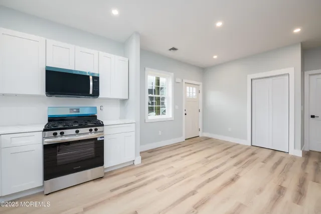 a kitchen with a stove and a microwave