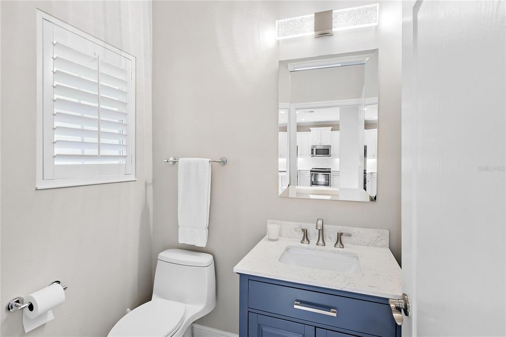 8142 Miramar Way Lakewood Ranch, FL 34202 - Photo 14 of 45 a bathroom with a toilet a sink a mirror and a window