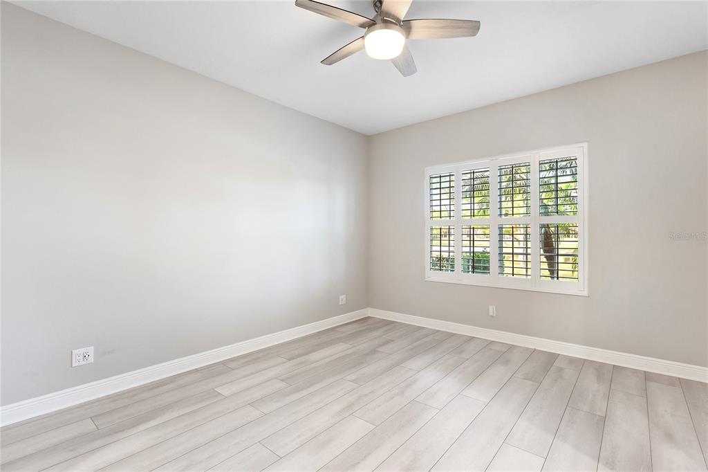 8142 Miramar Way Lakewood Ranch, FL 34202 - Photo 15 of 45 a view of an empty room with wooden floor and a window