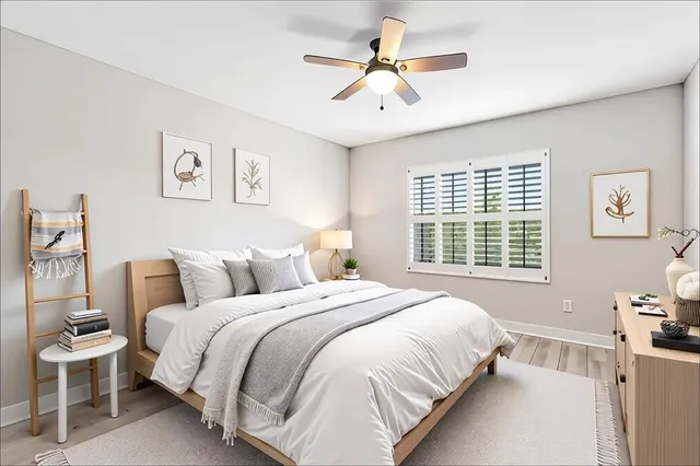 a bedroom with a large bed and a chandelier