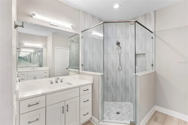 a bathroom with a shower sink and mirror