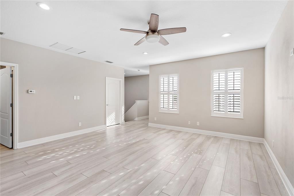 8142 Miramar Way Lakewood Ranch, FL 34202 - Photo 23 of 45 a view of an empty room with a window and wooden floor