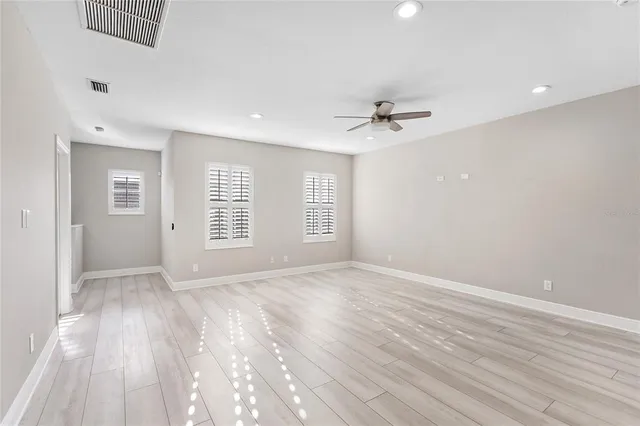 wooden floor in an empty room with a window