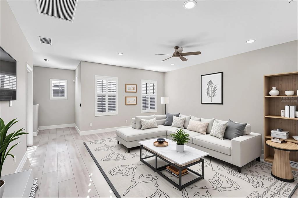 8142 Miramar Way Lakewood Ranch, FL 34202 - Photo 25 of 45 a living room with furniture and wooden floor