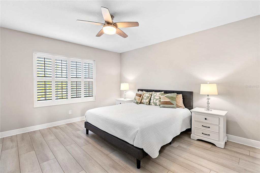 8142 Miramar Way Lakewood Ranch, FL 34202 - Photo 26 of 45 a bedroom with a bed and a chandelier