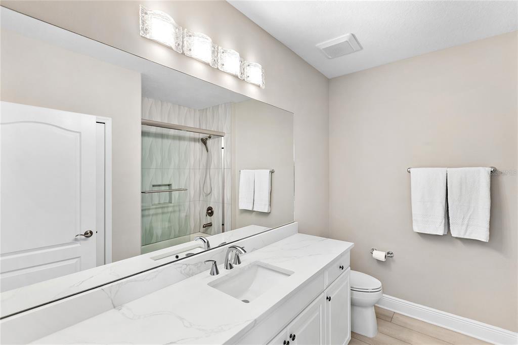 8142 Miramar Way Lakewood Ranch, FL 34202 - Photo 27 of 45 a bathroom with a sink a toilet a large mirror and shower