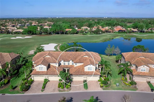 an aerial view of a house with garden space and ocean view