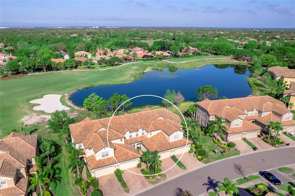 8142 Miramar Way Lakewood Ranch, FL 34202 - Photo 40 of 45 an aerial view of a house with a garden and lake view
