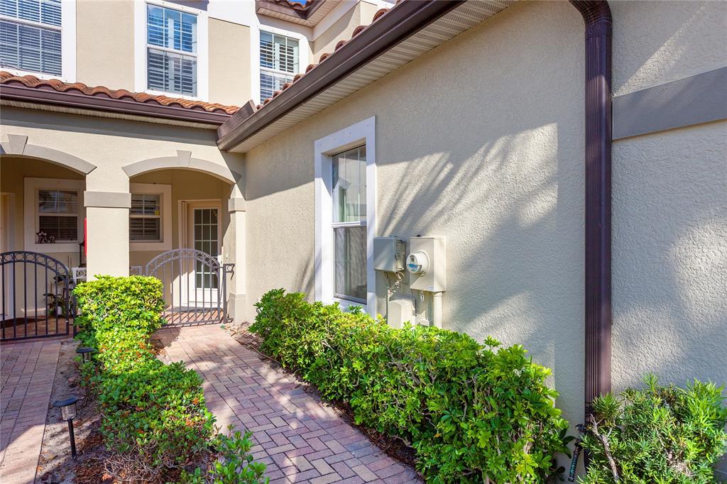 8142 Miramar Way Lakewood Ranch, FL 34202 - Photo 4 of 45 a front view of a house with garden