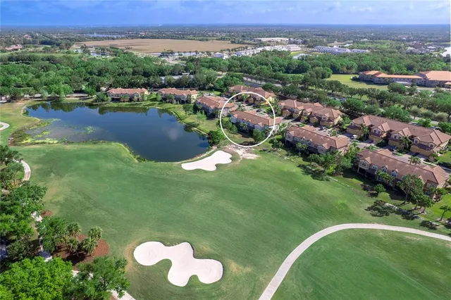 an aerial view of a golf course with parking space