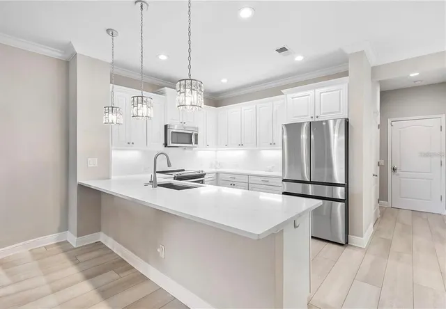 a kitchen with refrigerator cabinets and wooden floor