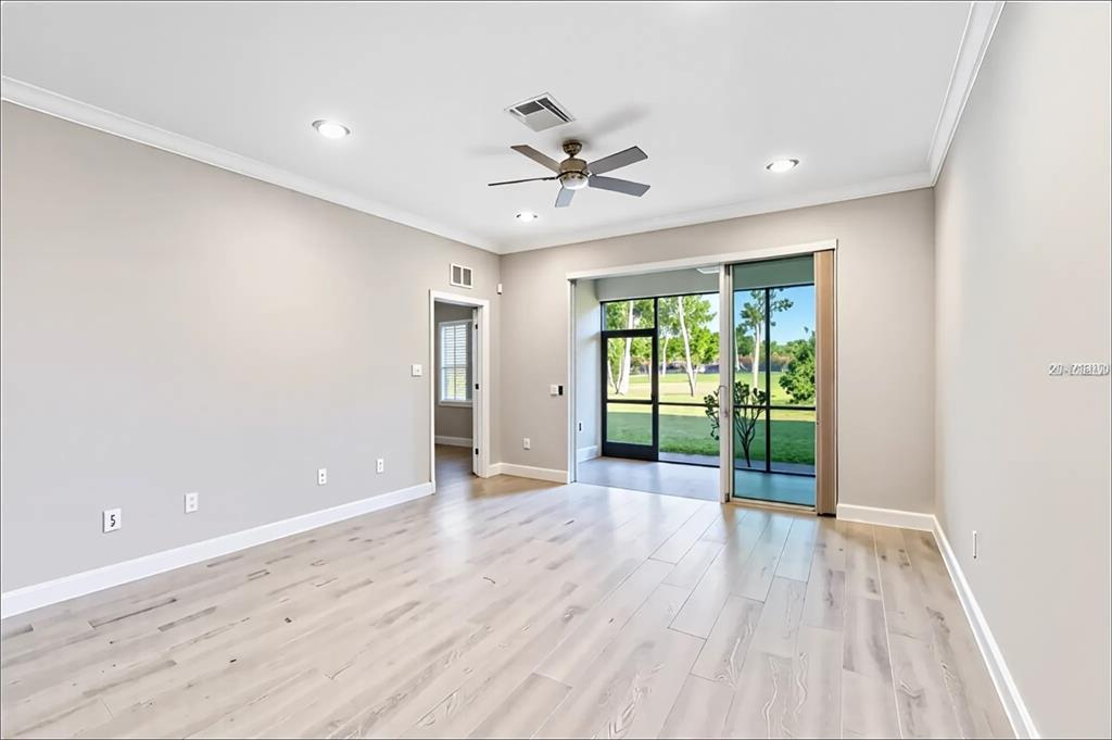 8142 Miramar Way Lakewood Ranch, FL 34202 - Photo 10 of 45 wooden floor in an empty room with a window