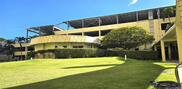 a view of swimming pool with a big yard and large trees