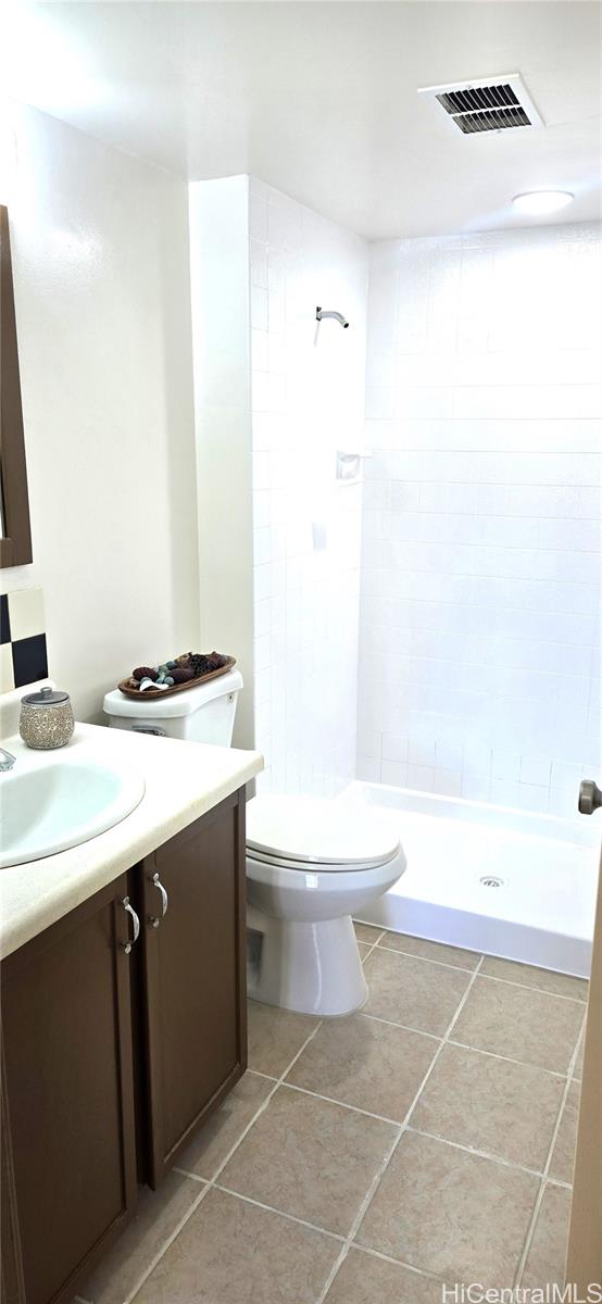 3161 Ala Ilima Street, Unit 309 Honolulu, HI 96818 - Photo 5 of 13 a bathroom with a sink a toilet and shower