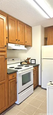 a kitchen with granite countertop a sink stainless steel appliances and cabinets