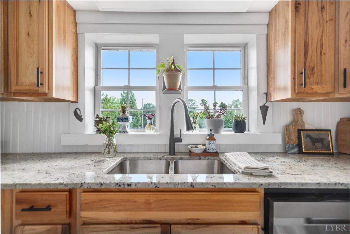 3733 Depot Road Rustburg, VA 24588 - Photo 17 of 58 a kitchen with granite countertop a sink and a window
