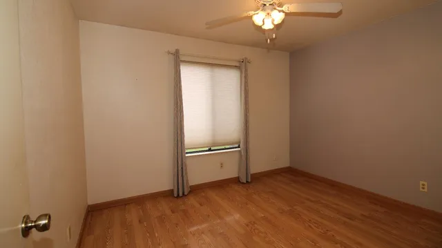 a view of a room with wooden floor and chandelier