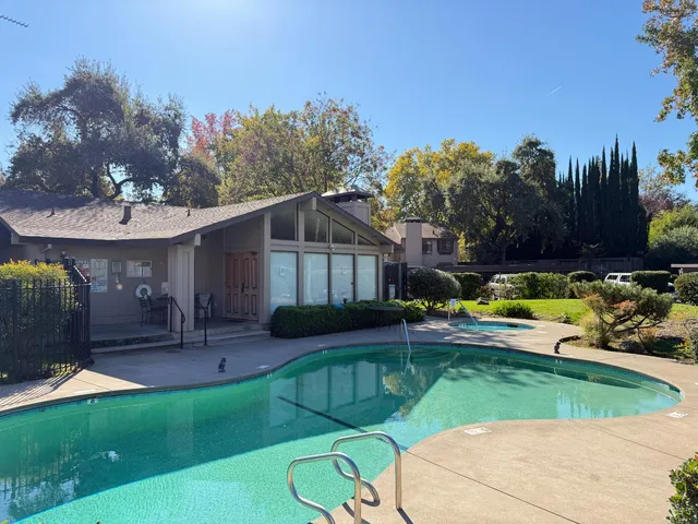 a view of a house with backyard porch and sitting area