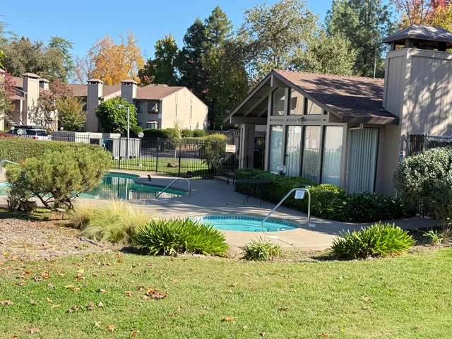 a view of a house with a yard and plants
