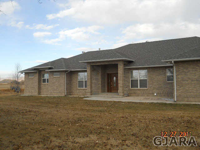 1634 M Road Fruita, CO 81521 - Photo 1 of 4 a front view of house with yard