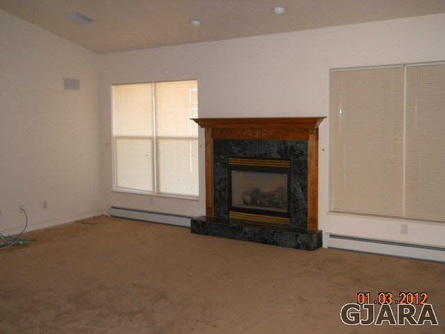 1634 M Road Fruita, CO 81521 - Photo 3 of 4 an empty room with a fireplace
