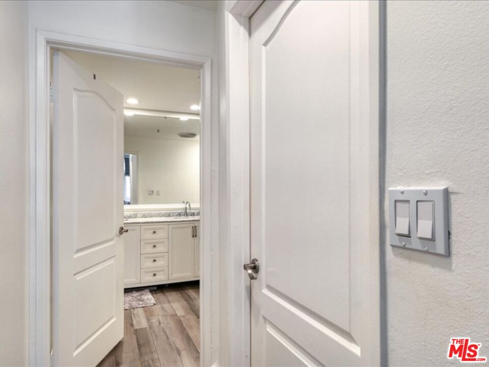 4477 Woodman Avenue, Unit 304 Sherman Oaks, CA 91423 - Photo 21 of 34 a bathroom with a granite countertop sink and a mirror