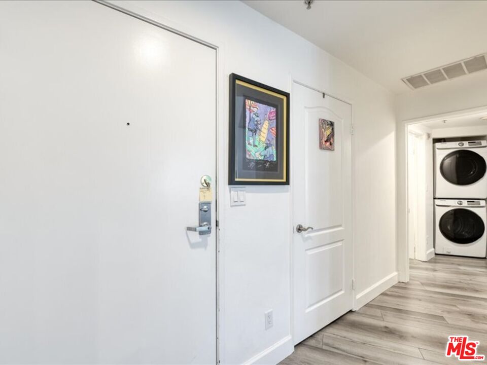 4477 Woodman Avenue, Unit 304 Sherman Oaks, CA 91423 - Photo 24 of 34 a view of a hallway with wooden floor and cabinets