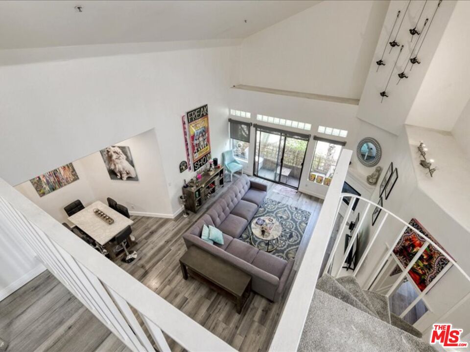 4477 Woodman Avenue, Unit 304 Sherman Oaks, CA 91423 - Photo 3 of 34 a living room with furniture and a flat screen tv