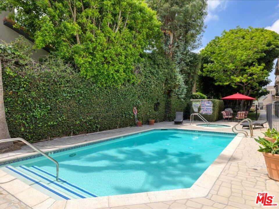 4477 Woodman Avenue, Unit 304 Sherman Oaks, CA 91423 - Photo 31 of 34 a view of a swimming pool with a patio