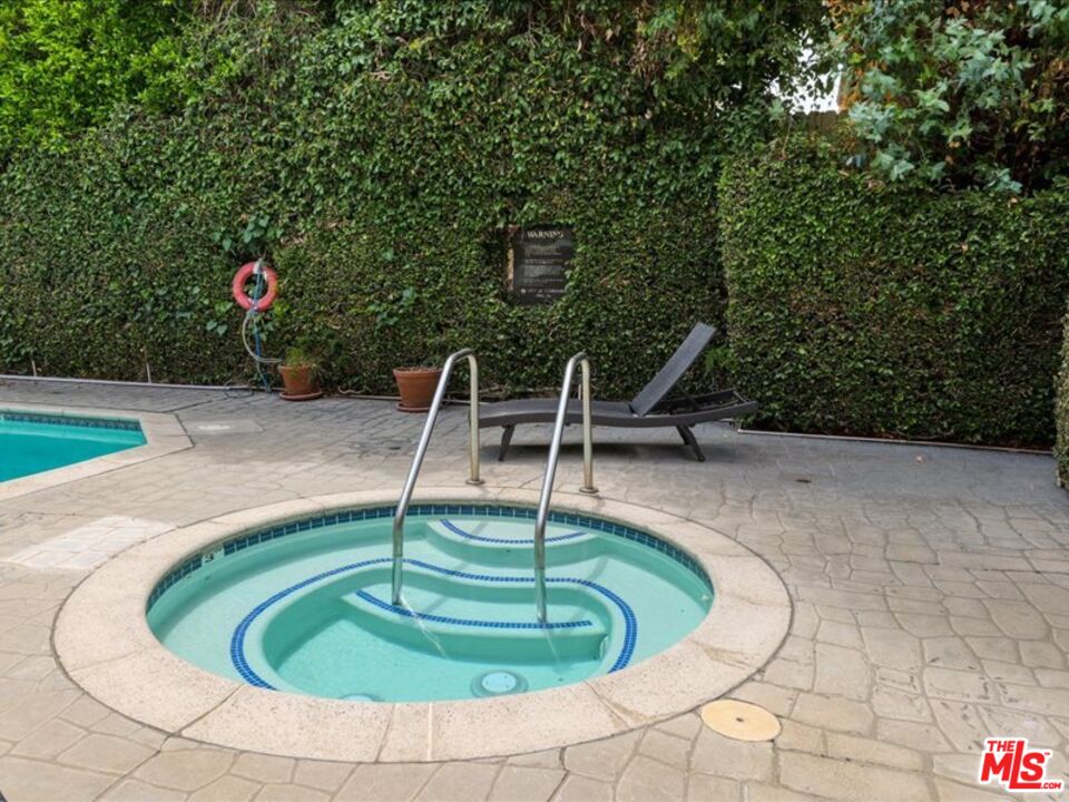 4477 Woodman Avenue, Unit 304 Sherman Oaks, CA 91423 - Photo 33 of 34 a swimming pool with lots of trees