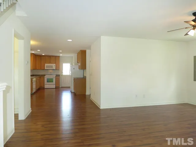 a view of a kitchen with a refrigerator and a stove top oven