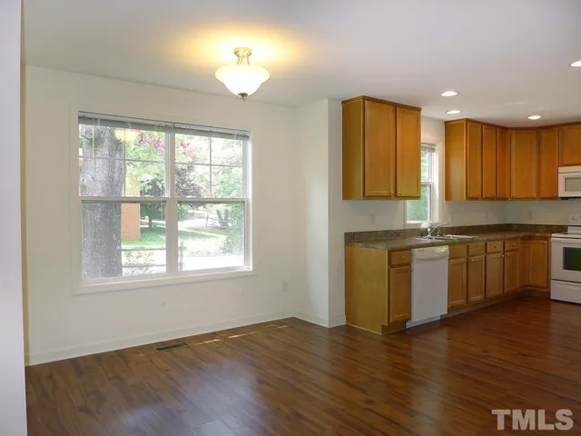 a kitchen with a refrigerator and window