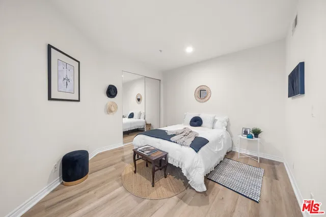 a bedroom with a bed and a couch