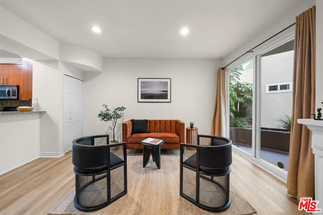 a living room with furniture a rug and a large window