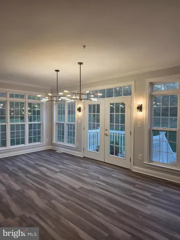a kitchen with stainless steel appliances granite countertop a sink a stove and a wooden floors